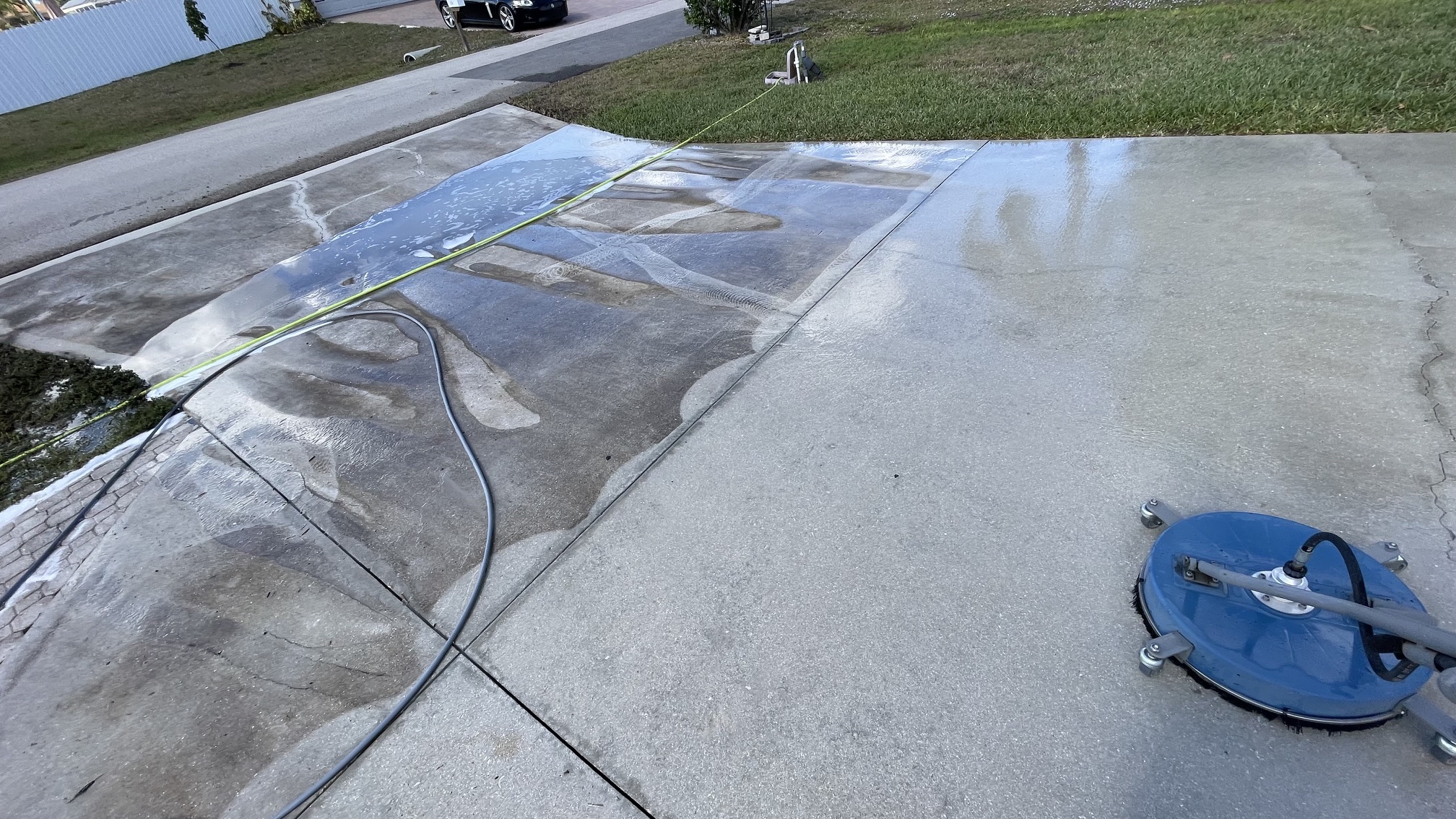 Driveway being cleaned with a surface cleaner
